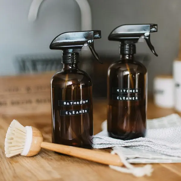 Spray bottles labeled bathroom and kitchen cleaner
