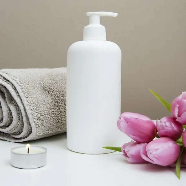 Rolled towel, tealight candle and pink tulips