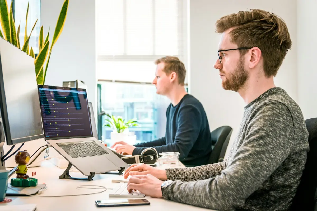 Developers working at their desks in a bright office