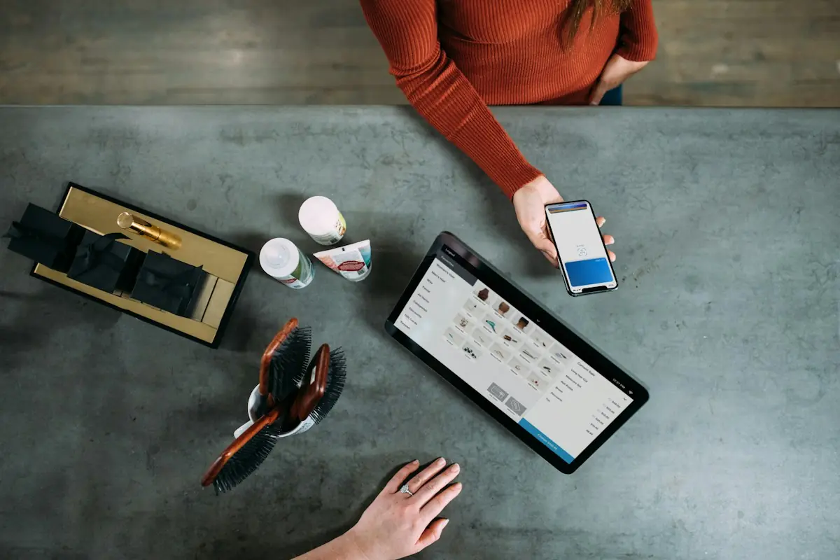 Customer paying by phone at a tablet point-of-sale