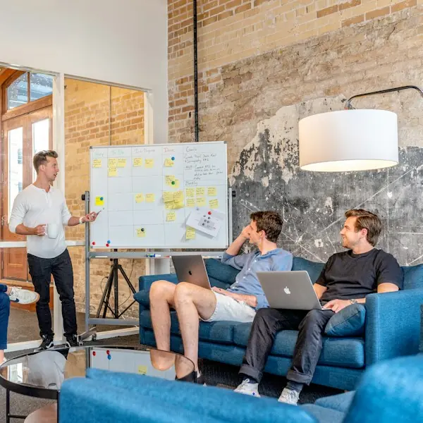 Team planning session at a whiteboard of sticky notes