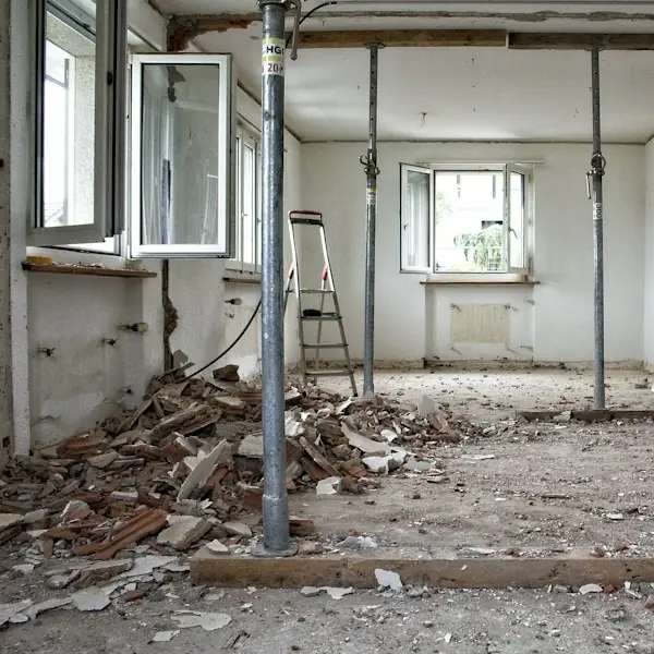 Gutted room during demolition with temporary supports