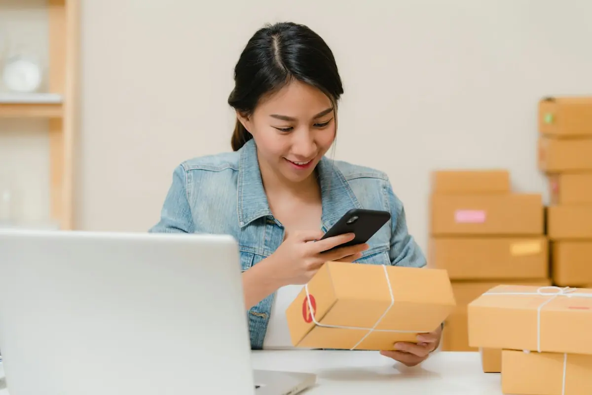 Small business owner photographing a packed order