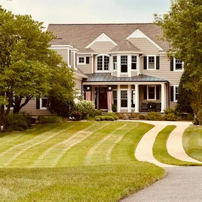 Freshly striped front lawn with a curved walkway